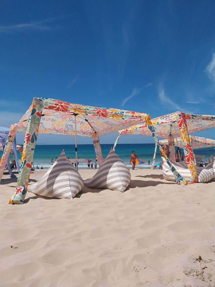 CoolCabanas beach cabanas and beanbags set up on the sand at Forster